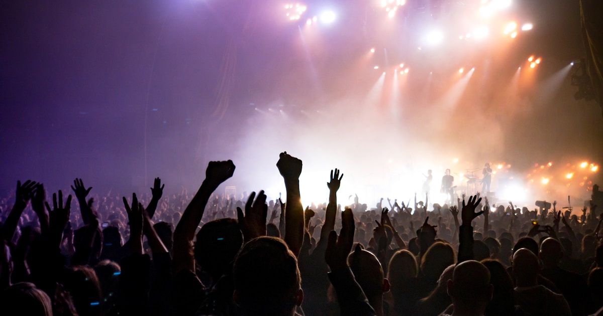 Evento lleno de asistentes disfrutando de un concierto